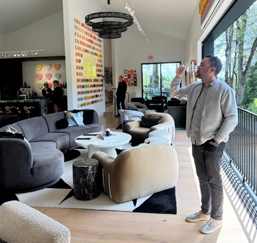 A young man enjoying a glass of wine inside the tasting room at Artist Block. 